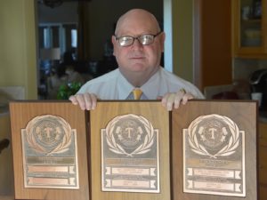 Roy Crawford with all three Distinguished District plaques, including the 2007-08.