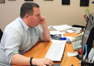 Kevin Wilson proofreads a newspaper article.